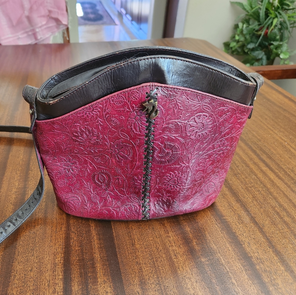 Tooled leather shoulder bag from Indian designer Riyu Kumar.  Burgundy/brown